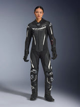 Alpinestars Stella GP-R7 1-Piece Leather Suit, Women's Motorcycle Racing Suit in Black and White, worn by a model with matching black racing gloves and boots, featuring perforated leather and integrated armor for track performance.