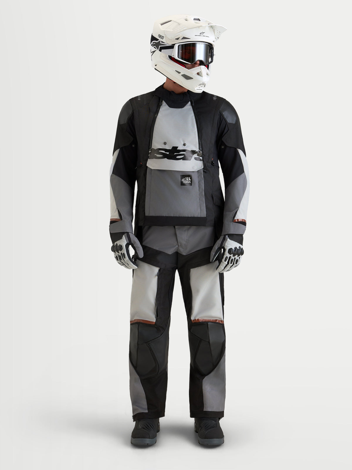 Alpinestars Harok V2 Drystar® Jacket, men's all-terrain adventure motorcycle textile jacket in dark gray, ice gray, and black, front view worn by a model wearing a matching helmet and gear, AA certified waterproof adventure riding apparel.