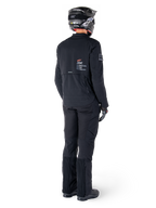Alpinestars AMT-8 Stretch Drystar® XF jakke, sort, set bagfra af en kører iført jakken med matchende sorte bukser og en sort hjelm, med 'Alpinestars Motion Technology' branding på ryggen, teknisk strækmateriale til adventure-motorcykelkørsel