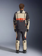 Alpinestars Halo Pro Drystar® XF lamineret jakke, adventure motorcykeljakke, Mastic Black med orange logo, set bagfra med stor branding på ryggen og modulære ventilationslynlåse, båret med matchende adventure-bukser til terrænkørsel