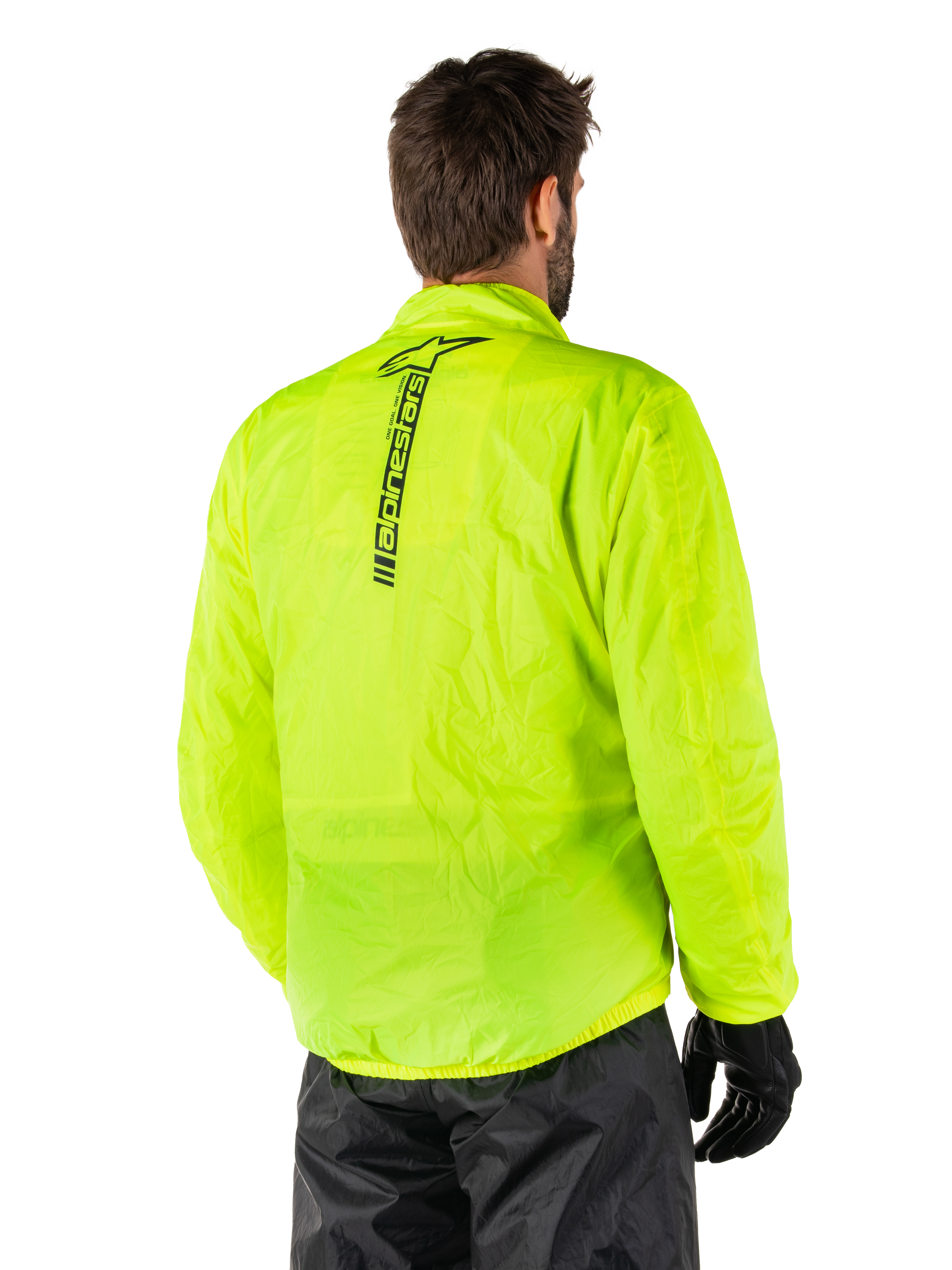 Alpinestars Hurricane Rain V2 Jakke, Yellow Fluo, set bagfra på mandlig model, lodret sort Alpinestars-ordmærke på ryggen, elastik i talje og manchetter, vandtæt og sammenpakbart design