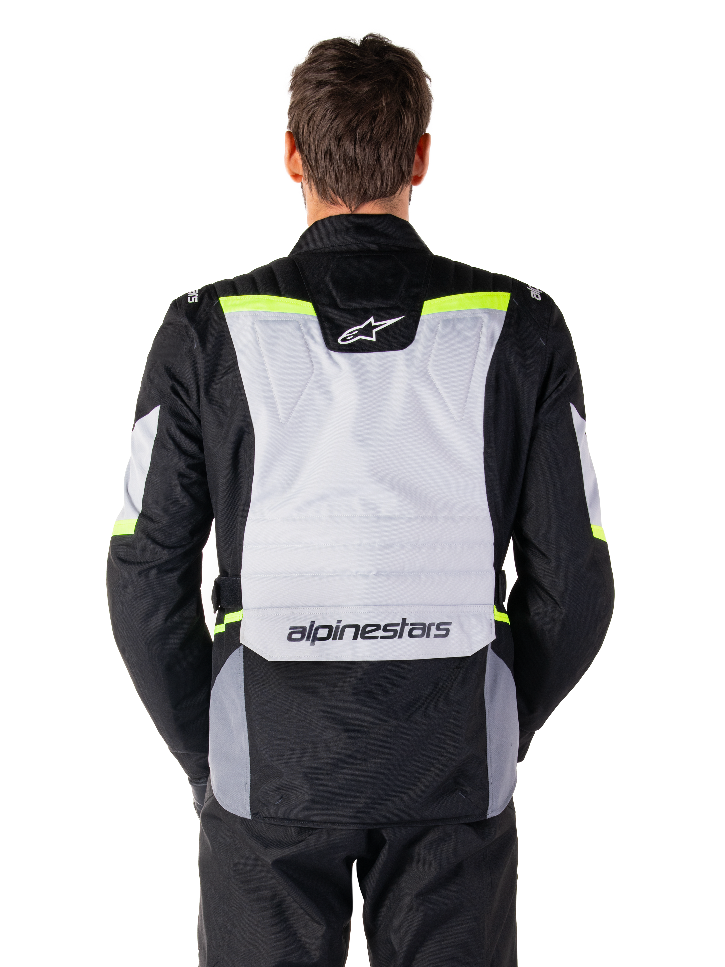 Alpinestars ST-1 Waterproof Jacket, Adventure Touring Jacket, Ice Gray Black and Yellow Fluo, back view on a model, featuring a light gray rear panel with Alpinestars logos, neon yellow accents, and streamlined protective design
