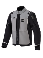 Alpinestars Andes Pro Drystar® XF jakke, adventure motorcykeljakke, mørkegrå og sort, med grå brystpaneler samt sorte ærmer og sider, 'ALL TERRA' branding på brystet, Alpinestars-logo på skuldrene, teknisk tekstilkonstruktion med ventilationslynlåse og justerbare manchetter.