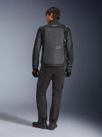 Alpinestars Cusco Drystar® Jacket, sort og mørkegrå med blå detaljer, set bagfra, båret med matchende sorte adventure-bukser og handsker, med et stort gråt rygpanel og hvidt logo på kraven, designet til vej- og adventure-touring
