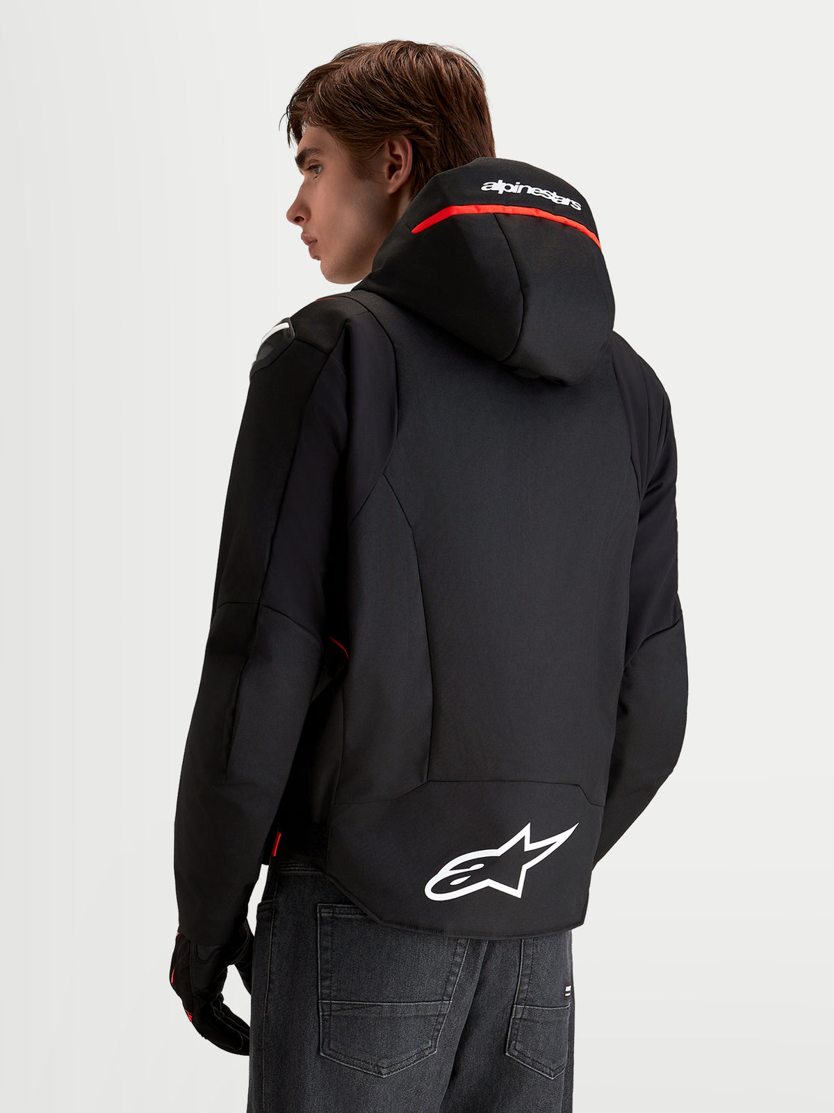 Alpinestars Zaca V2 Waterproof Jacket, Men's motorcycle riding jacket in Black and Red Fluo, featuring an integrated hood with Alpinestars branding, extended rear hem with white Astar logo, and stretch softshell construction