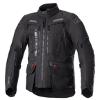 Alpinestars Bogota Pro Drystar jakke, helsort motorcykel touringjakke, grå og røde detaljer, store ventilationspaneler på brystet, vandtætte lommer med røde snoretræk, høj beskyttende krave, slidstærk tekstilkonstruktion til adventure-kørsel