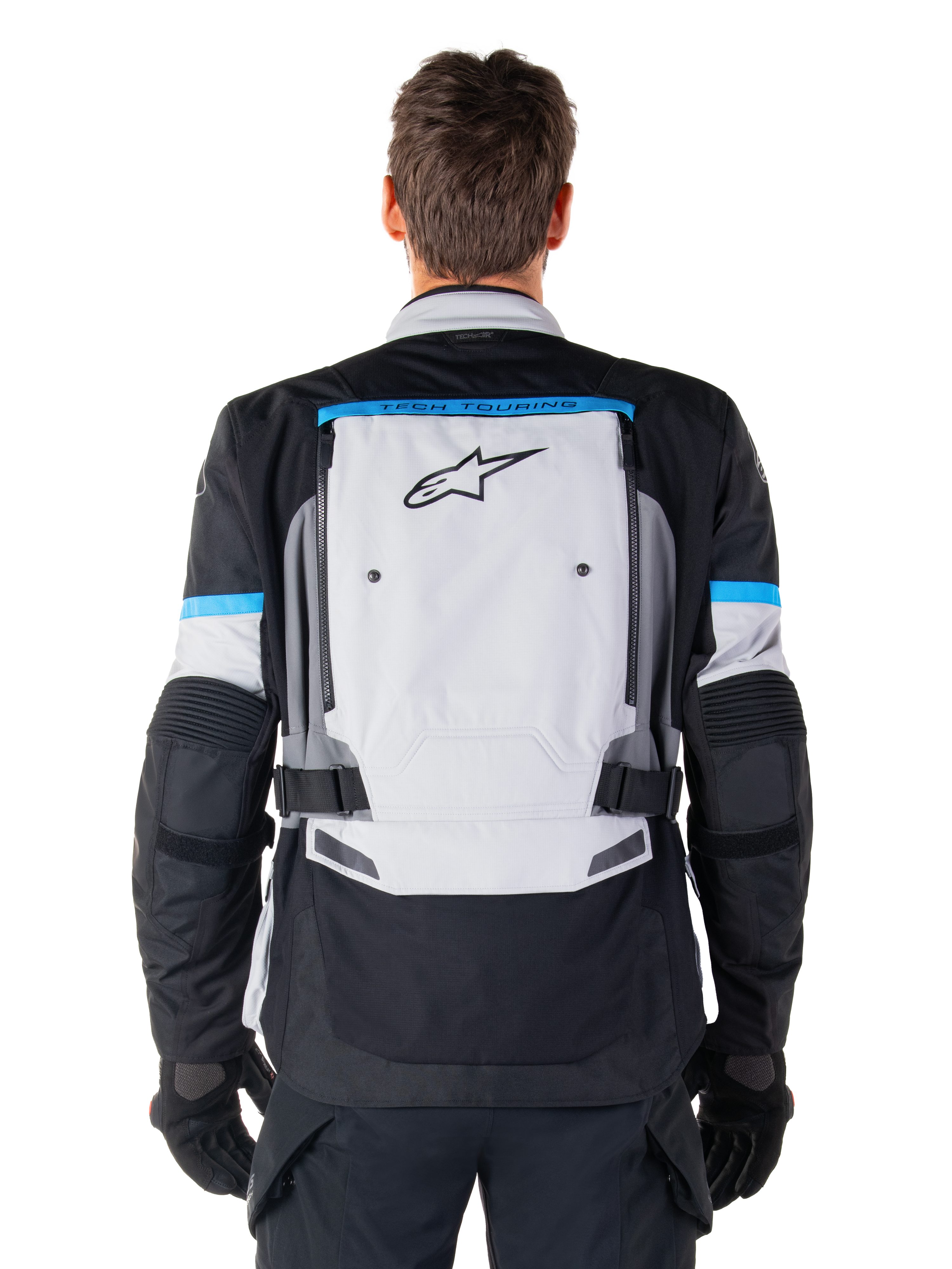 Alpinestars Bogota' Pro Drystar® jakke, adventure-motorcykeljakke, Ice Gray Black og Cyan, set bagfra med et stort lysegråt panel med sort stjerne-logo, cyanfarvede detaljer med Tech Touring-branding og justerbare taljeremme