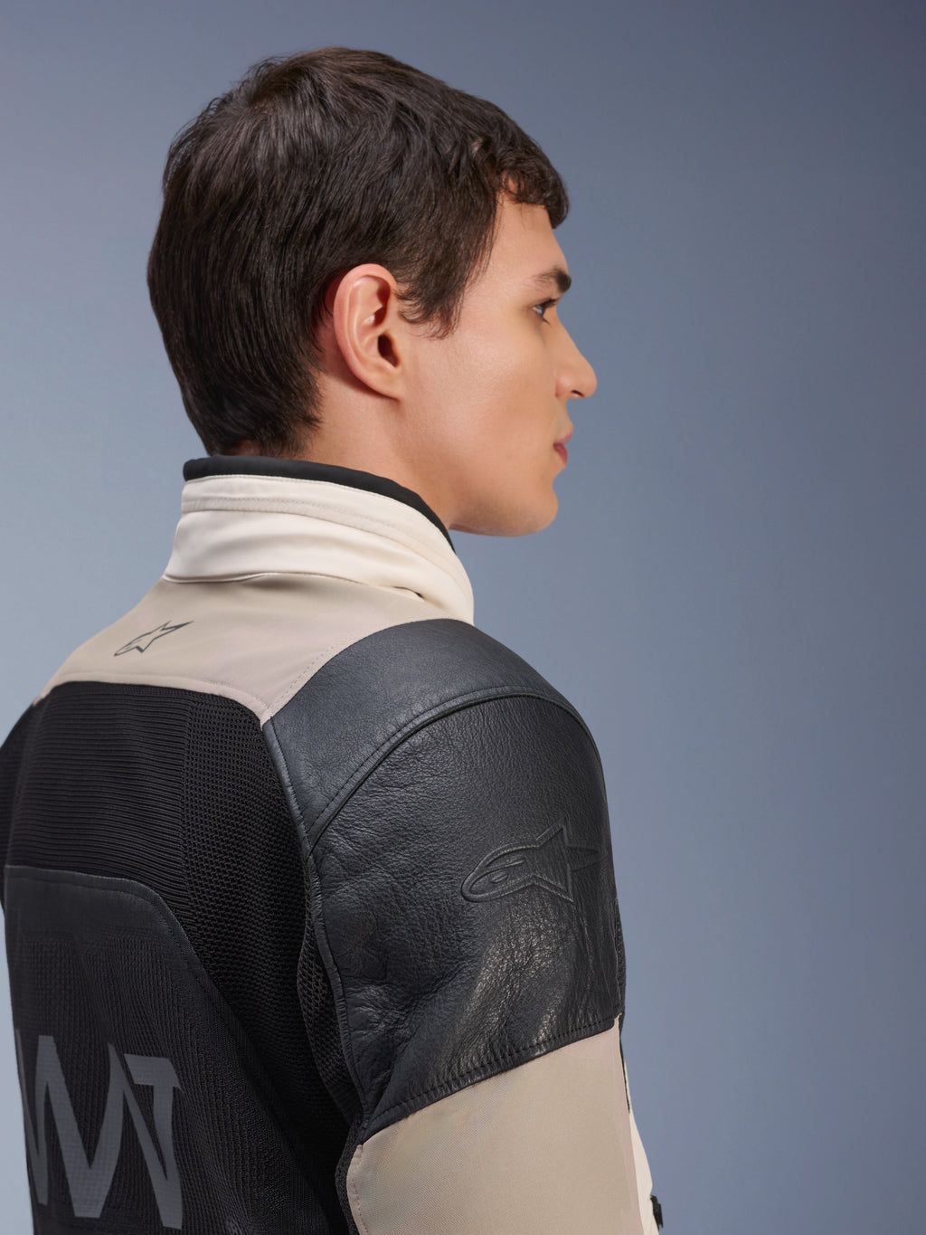 Alpinestars AMT-10LAB Drystar® XF-jakke, adventure motorcykeljakke, White Sand og sort, sideprofil der viser sort læderskulder med præget logo, MATYRX® mesh-rygpanel med AMT-branding, modulært beskyttende design til al slags vejr.