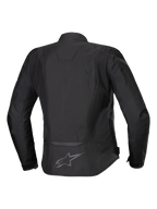 Alpinestars Stella T-Jaws V4 vandtæt jakke, tekstil motorcykeljakke til kvinder, sort på sort, set bagfra, ergonomisk sports-silhuet, reflekterende detaljer og logo på den nederste del af ryggen.
