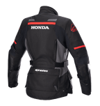 Alpinestars Dame Stella Honda Andes V3 Drystar® Jakke, motorcykel adventure-jakke, sort, mørkegrå og klar rød, set bagfra med markant hvidt HONDA-logo og rød Alpinestars-grafik, vandtæt tekstilkonstruktion med justerbar talje og praktiske lommer