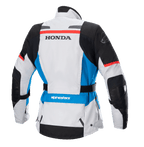 Alpinestars Stella Honda Andes V3 Drystar® damejakke, set bagfra, isgrå med blå og stærkt røde detaljer, markant sort HONDA-branding på ryggen, Alpinestars-logo på skulder og lænd, justerbart taljebælte, adventure touring tekstil motorcykeljakke