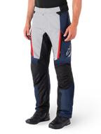 Alpinestars St-1 Waterproof Pants, Motorcycle Touring Pants, Dark Blue Black and Bright Red, featuring light grey front panels with red zipper accents, black reinforced knee sections, and a white Alpinestars logo on the side, worn with black motorcycle boots.