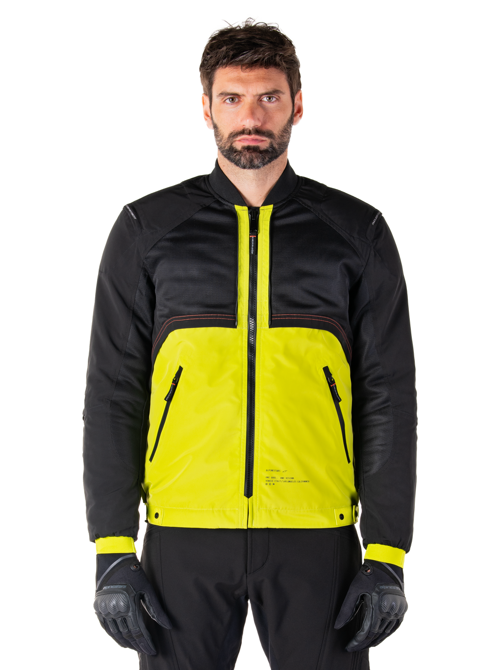 Alpinestars Mootant Waterproof Parka, modulær motorcykeljakke, Lime Punch og sort, båret af en mandlig model med sorte handsker og bukser, med en livlig gul underdel og sort overkrop og ærmer, utilitaristisk design til kørsel i alt slags vejr