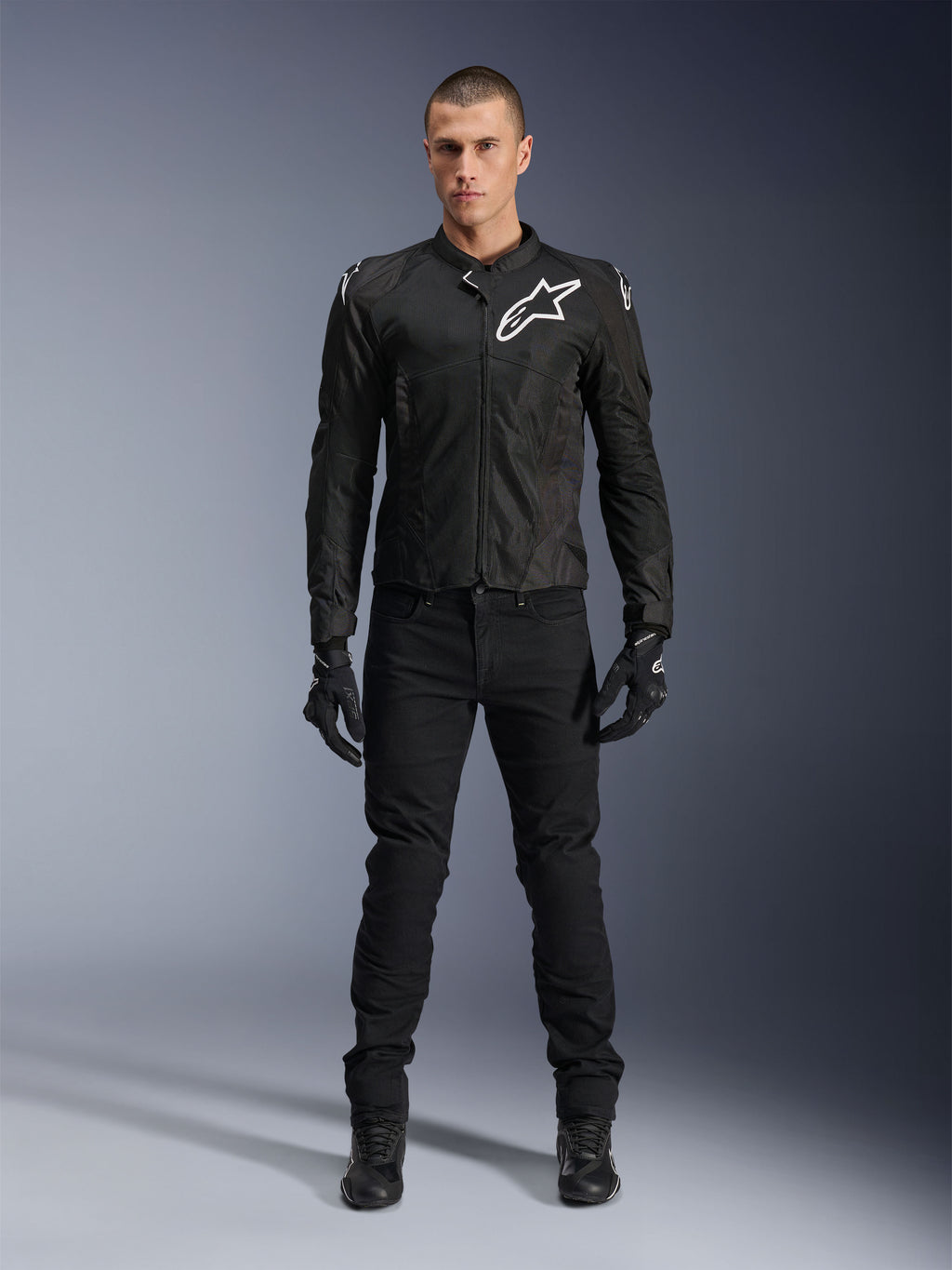 Alpinestars Viper Air V4 Jacket, Black textile motorcycle jacket, white logo on chest and shoulders, worn with black riding pants and gloves, features tech mesh panels for airflow, full-body studio view