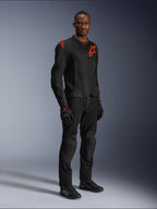 Model wearing Alpinestars Viper Air V4 Jacket in Black and Red Fluo, featuring mesh panels and red star logos on the chest and shoulder, paired with matching black motorcycle pants, gloves, and riding shoes, professional road riding gear ensemble