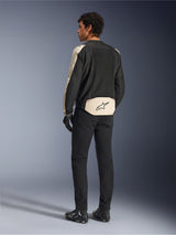 Alpinestars T-SPS Air V2 jakke, tekstil motorcykeljakke, Black Mastic Aluminum, set bagfra på model, med omfattende tech mesh-paneler for optimal luftgennemstrømning, beige detaljer på ærmer og lænd med Alpinestars-logo, kombineret med sorte bukser og støvler.