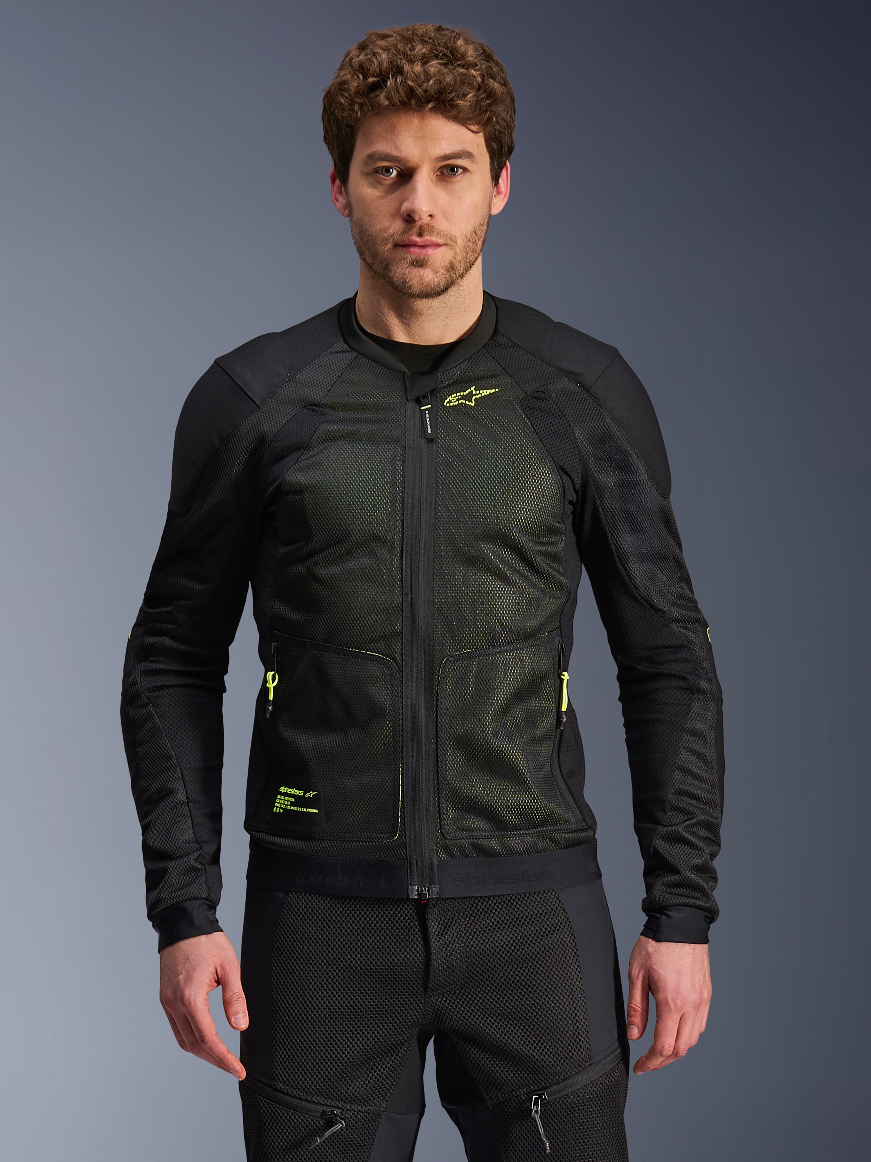 Alpinestars Troop-Air Jacket, Black and Yellow Fluo, worn by male model, featuring lightweight mesh construction, neon yellow zippers and branding, technical ventilated motorcycle jacket for urban riding