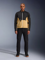 Alpinestars Provoke Jacket in Black Camel, urban motorcycle jacket featuring a two-tone black and camel design, worn by a model with black pants and black shoes, contemporary silhouette with white zippers and technical softshell construction.