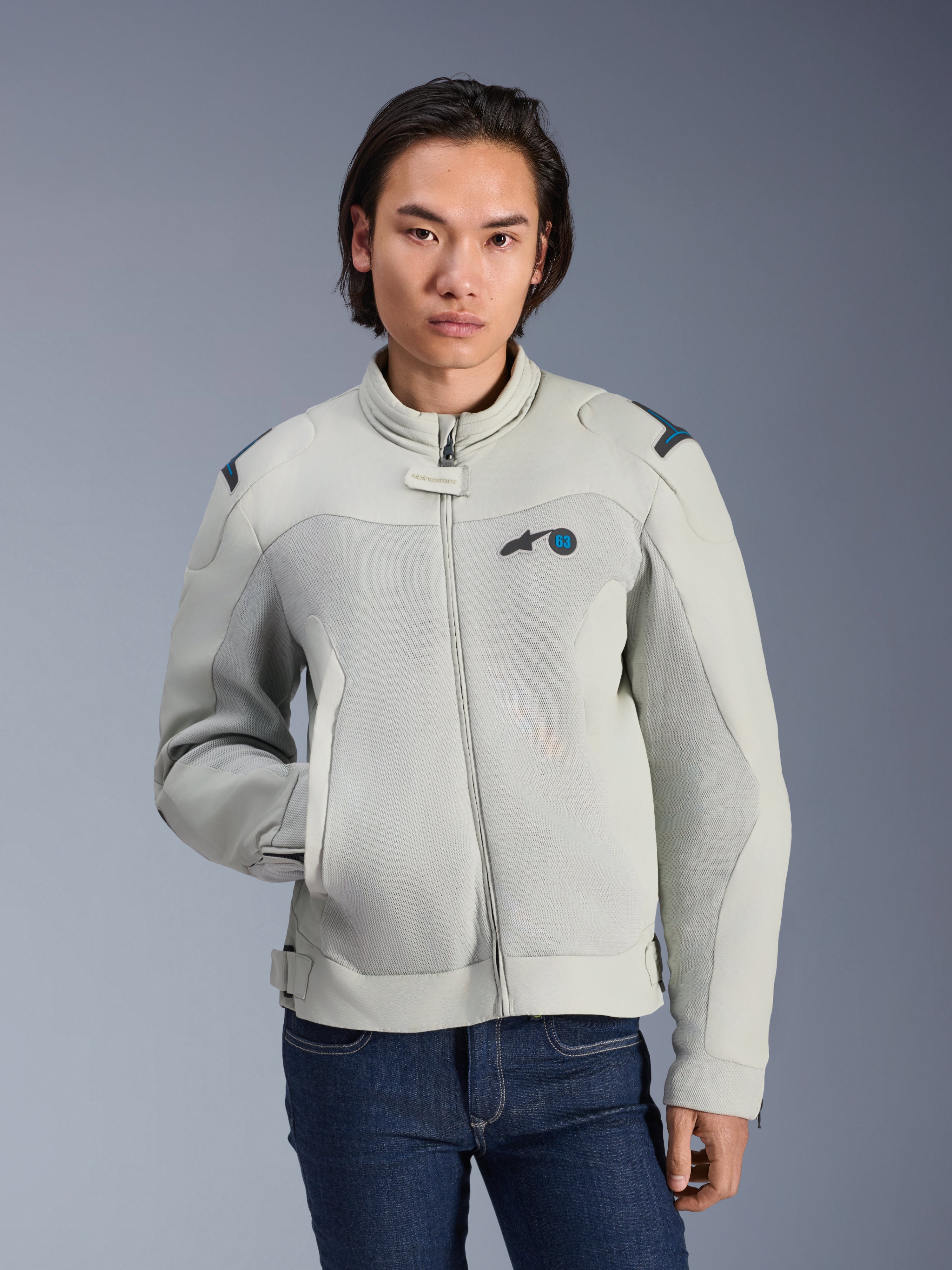 Alpinestars Circal-1 Air Jacket, Metal Gray and Methyl Blue, urban motorcycle jacket with mesh airflow panels, zip front and padded collar, worn by a model with blue jeans, futuristic sustainable design for summer riding