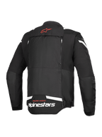 Alpinestars T-Stunt Air-jakke, set bagfra, sort og hvid, med rødt stjernelogo i nakken, hvid branding på den nederste del af ryggen og lodrette lynlåse til det modulære luftstrømssystem.