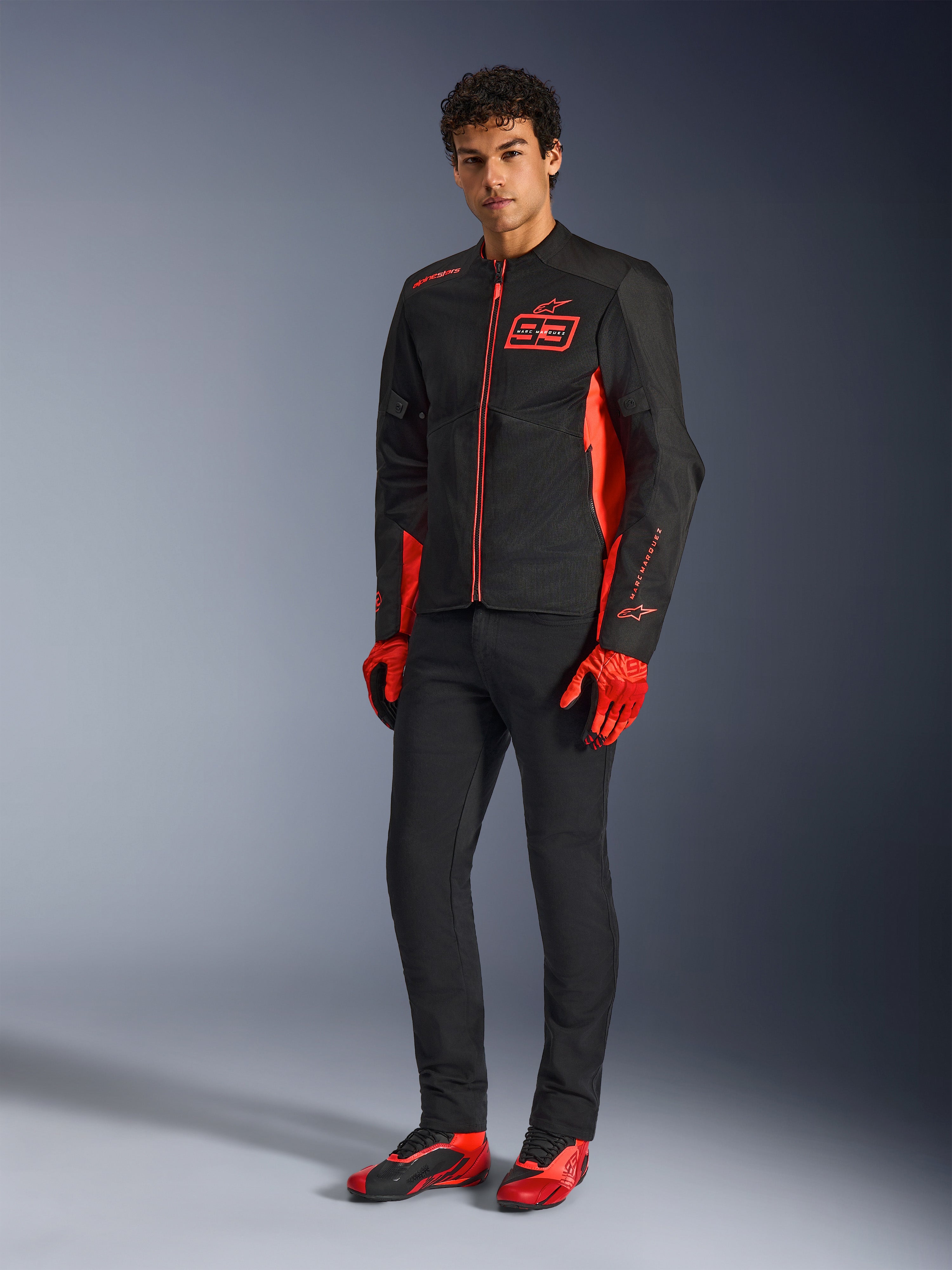 Alpinestars MM93 C-1 Air-jakke, motorcykeljakke, fluorød, klar rød og sort, vist med røde handsker, sorte bukser og røde køresko, med MM93-branding og letvægts mesh-konstruktion, moderne urbant køreudstyr