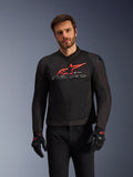 Alpinestars SMX Air-jakke, motorcykel racing- og sportsjakke, sort med klare røde og hvide detaljer, med et stort rødt logo og hvidt brandnavn på brystet, teknisk mesh-konstruktion til ventilation, båret af en model med sorte kørehandsker og bukser