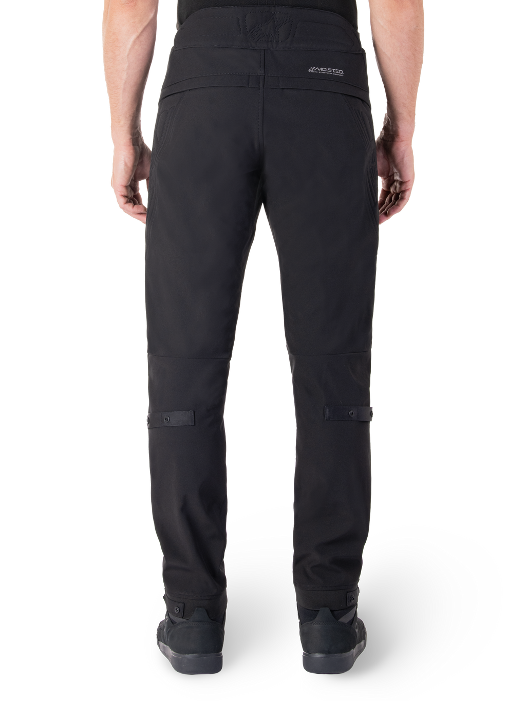 Alpinestars Alden bukser, sorte urban motorcykelbukser, set bagfra, med reflekterende MO.ST.EQ.-ordmærke på bagstykket, slim fit under knæet og volumenjusteringer med trykknapper på læggene og manchetterne, streetwear-inspireret teknisk tekstildesign