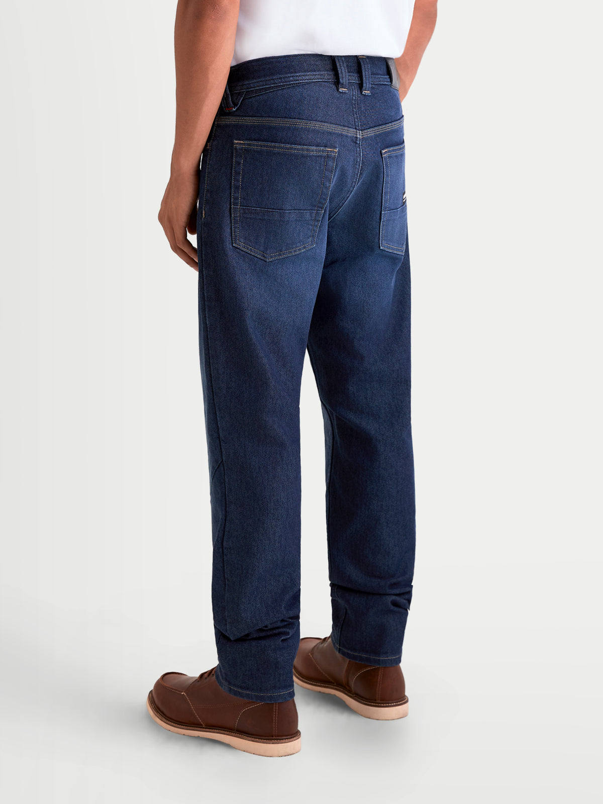 Alpinestars Flex-AST 7 Denim Pants, men's urban motorcycle riding jeans, dark blue, rear view showing single-layer technical denim construction, five-pocket layout, and leather back patch worn by a model.