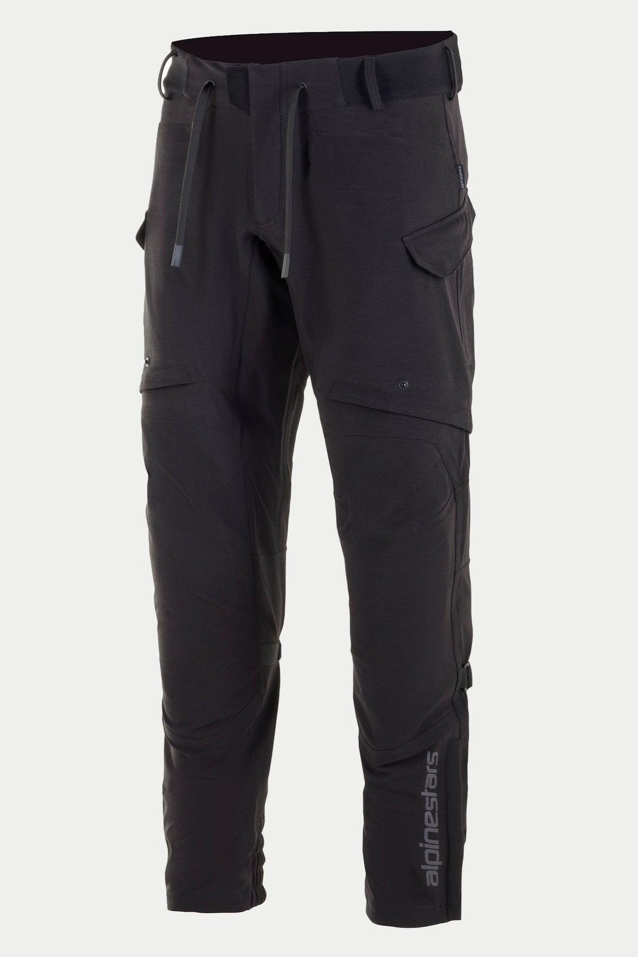 Alpinestars Juggernaut Waterproof Pants, Motorcycle Pants, Black, featuring a drawstring waist and elasticated waistband, zippered cargo pockets on the thighs, vertical Alpinestars logo on the lower leg, casually-styled softshell textile construction