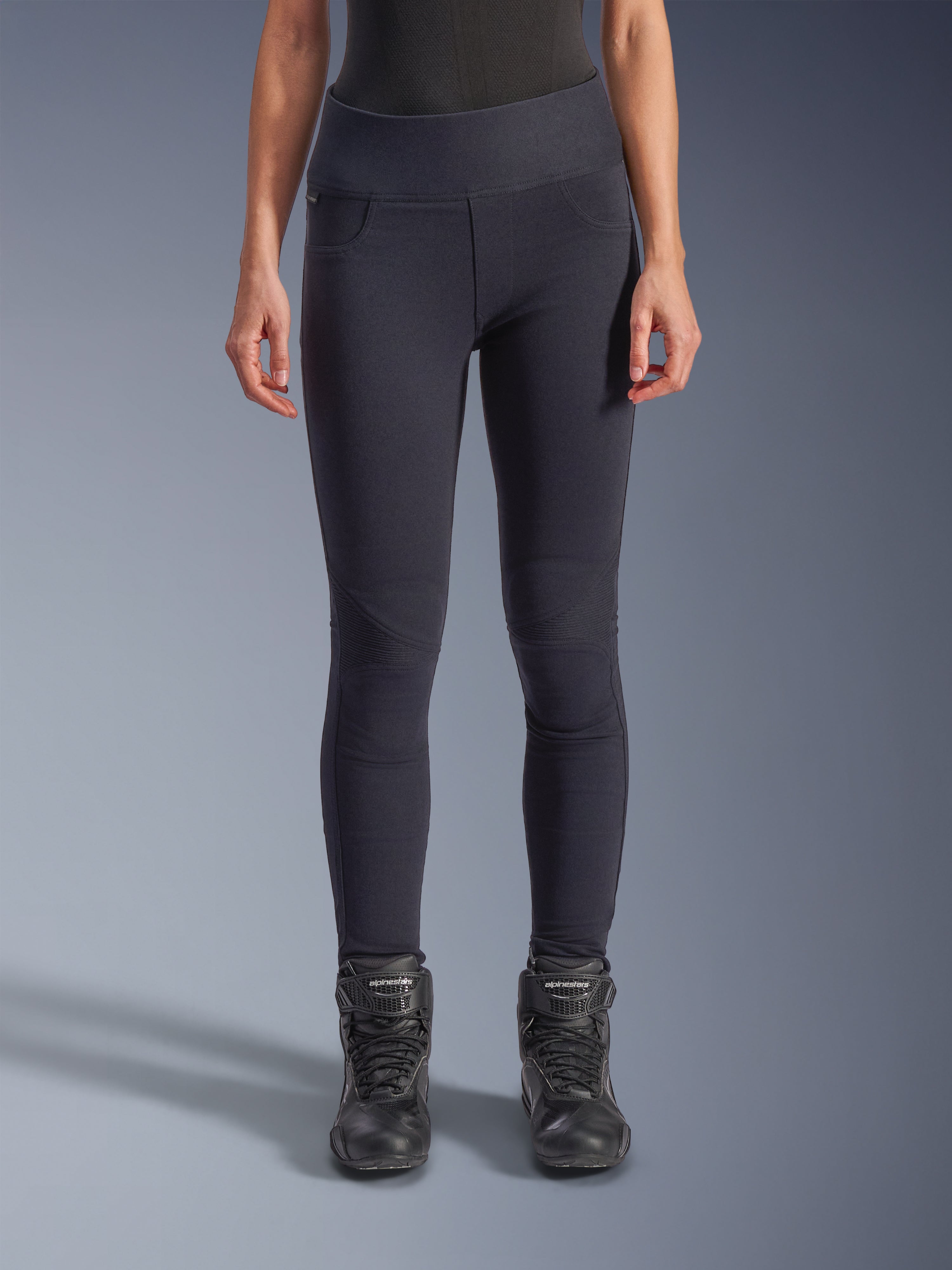 Alpinestars Stella Flex-Ast leggings, motorcykel-leggings til damer, sort, højtaljet pasform med artikulerede knæpaneler og kontursømme, båret af model med sorte kørestøvler, urbant performance-køreudstyr