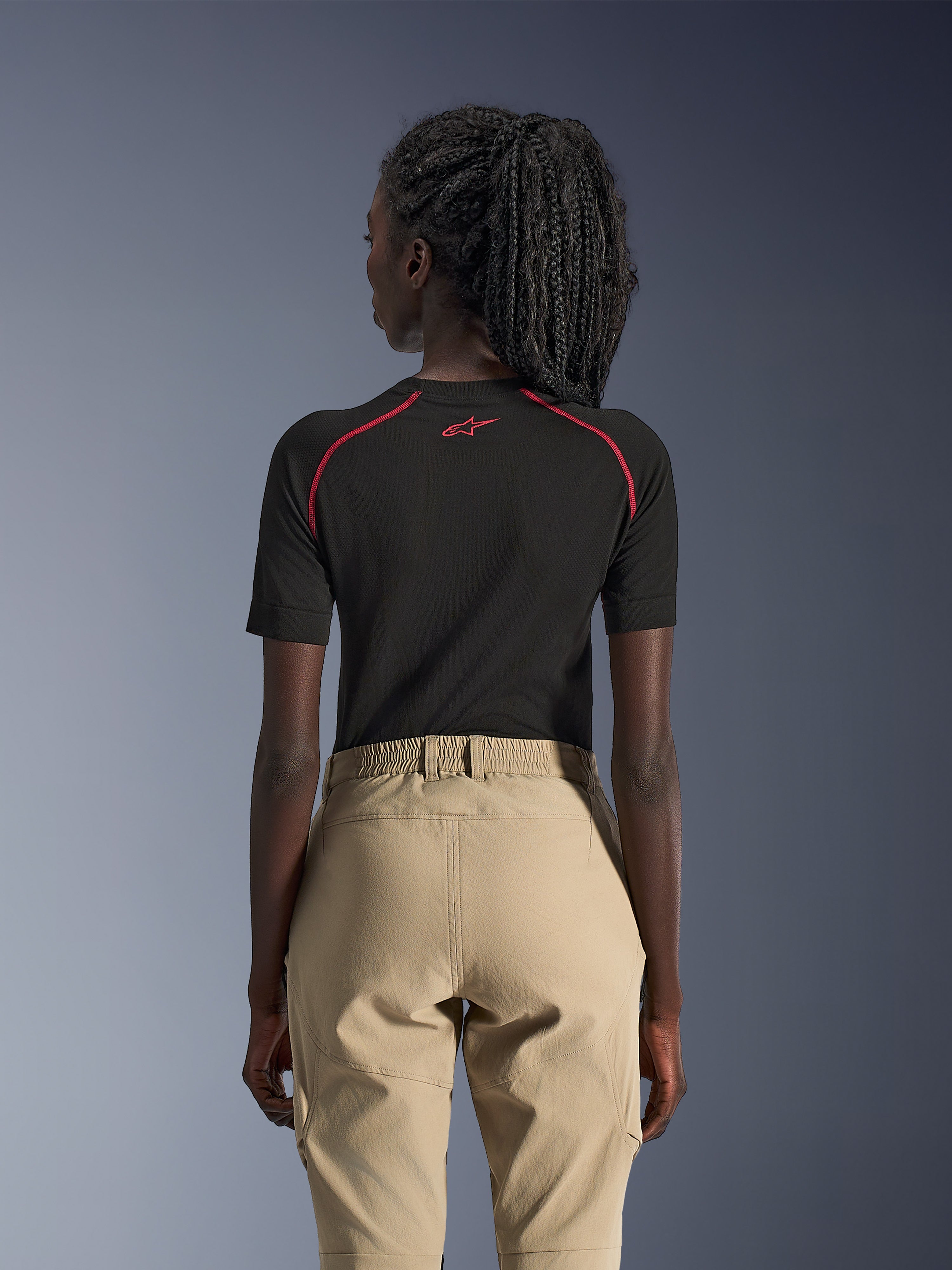 Alpinestars Woman Stella Flex-AST Explorer Pants, Sand, Adventure Motorcycle Pants, rear view worn with a black short-sleeve base layer with red accents, features elastic waistband and durable textile construction