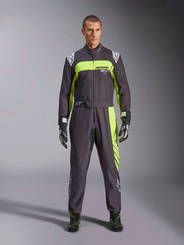 Alpinestars KMX-9 V3 Graphic 3 Suit, Black and Yellow Fluo, professional one-piece karting suit worn by a model, featuring bold neon yellow accents, ASTARS branding on the chest, and matching racing gloves and boots.