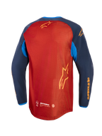 Alpinestars Maxdura Dual Jersey, adventure-motorcykeltrøje, rustbrun og Mood Indigo med lyseblå detaljer, set bagfra med fuld mesh-torso, forlænget bagkant og gul Alpinestars-branding på ærmer og ryg