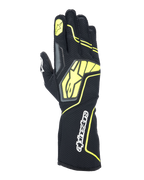 Alpinestars Tech-1 KX V4 handsker, karting racinghandsker, Tar Gray, sort og fluorescerende gul, set fra håndryggen med åndbar mesh-konstruktion, stort gult Alpinestars-logo, hvidt navnetræk på håndleddet, gul stjerne på pegefingeren, moderne sportsligt design