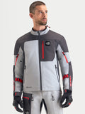 Alpinestars Arenis Gore-Tex Jacket, men's adventure touring motorcycle jacket in mid gray, deep gray, and black, front view worn by a model showing waterproof textile construction and zippered chest pocket