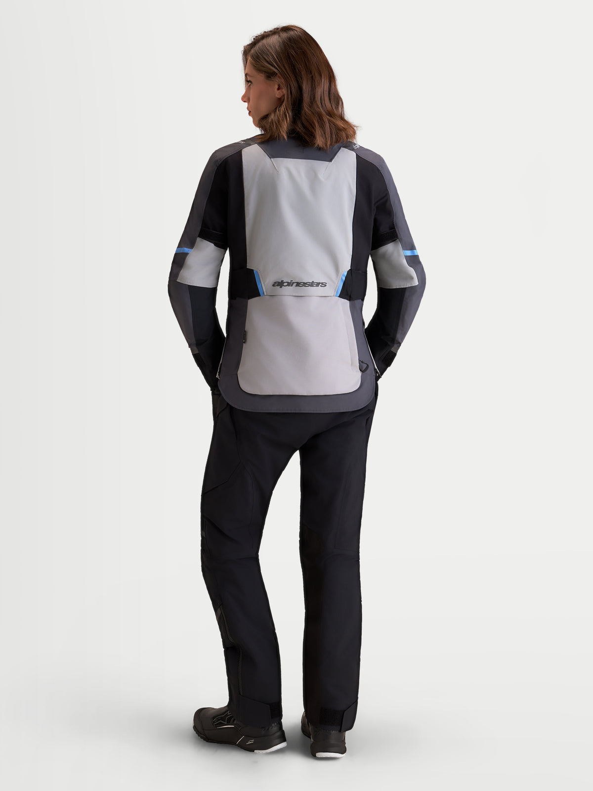 Alpinestars Stella St-7 V2 2L Gore-Tex Jacket, women's adventure touring motorcycle jacket in mid gray, deep gray, and black, rear view on a model showing waterproof textile construction and ergonomic back panel.