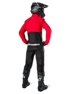 Alpinestars Pro-Dura jakke, motocrossrytter set bagfra, sort, klar rød og hvid, kombineret med sorte bukser, sort hjelm og sorte off-road støvler, rød overdel og sort underdel med hvidt logo på ryggen, off-road racingudstyr