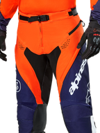 Alpinestars Pro-Dura Pants, Enduro Motorcycle Pants, Navy Hot Orange and White, detail view of the waist featuring SX2 magnetic buckle and zippered thigh vents, durable ripstop material with bold branding, worn with matching gear