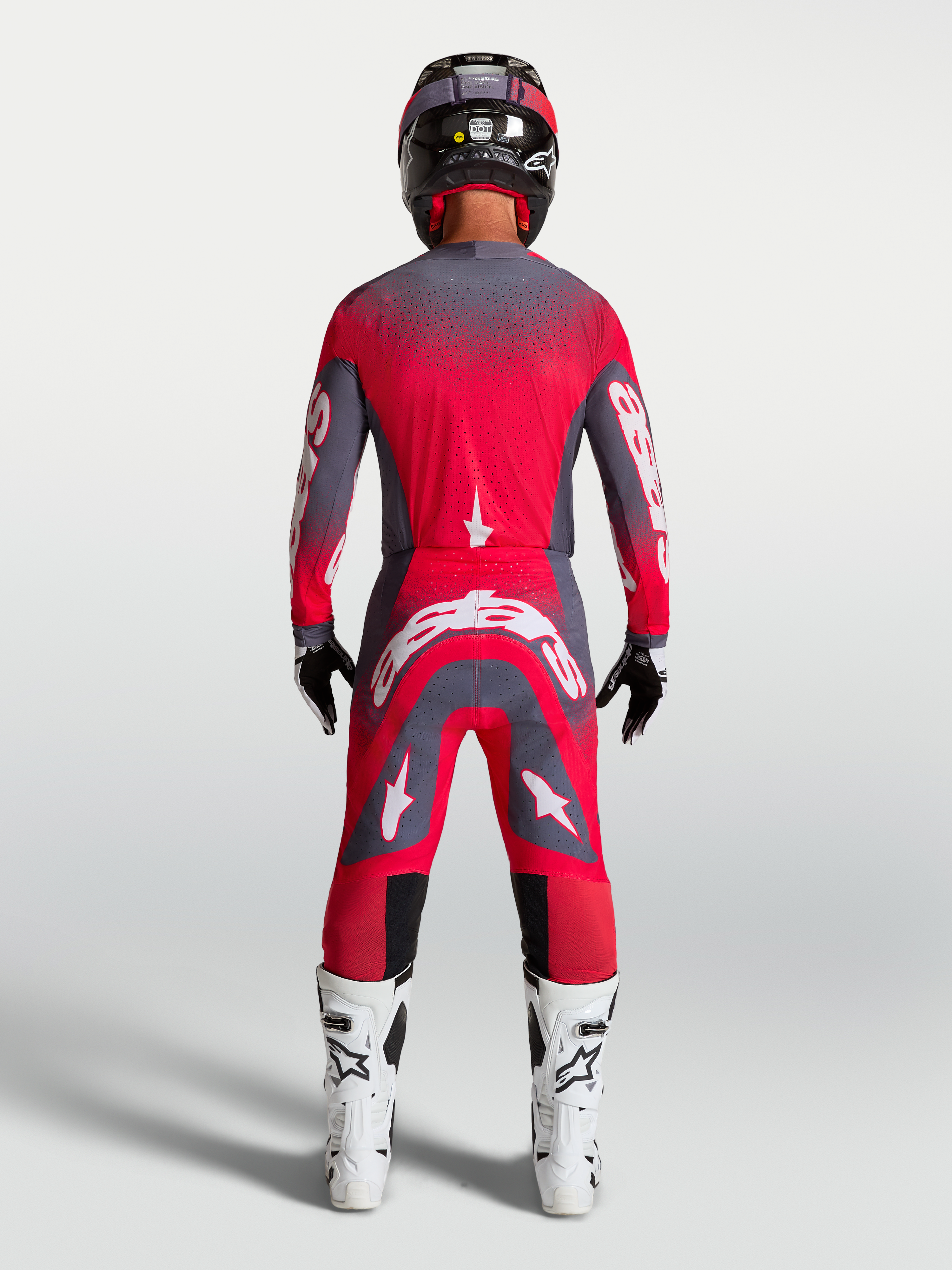 Alpinestars Supertech Hiten AFD Gear Set AND Pants, Motocross Racing Gear, Red Fluo and Graystone, rear view on model.