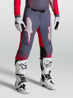 Alpinestars Supertech Hiten AFD Pants, grey and fluo red motocross pants with white star graphics and magnetic buckle, worn with boots.
