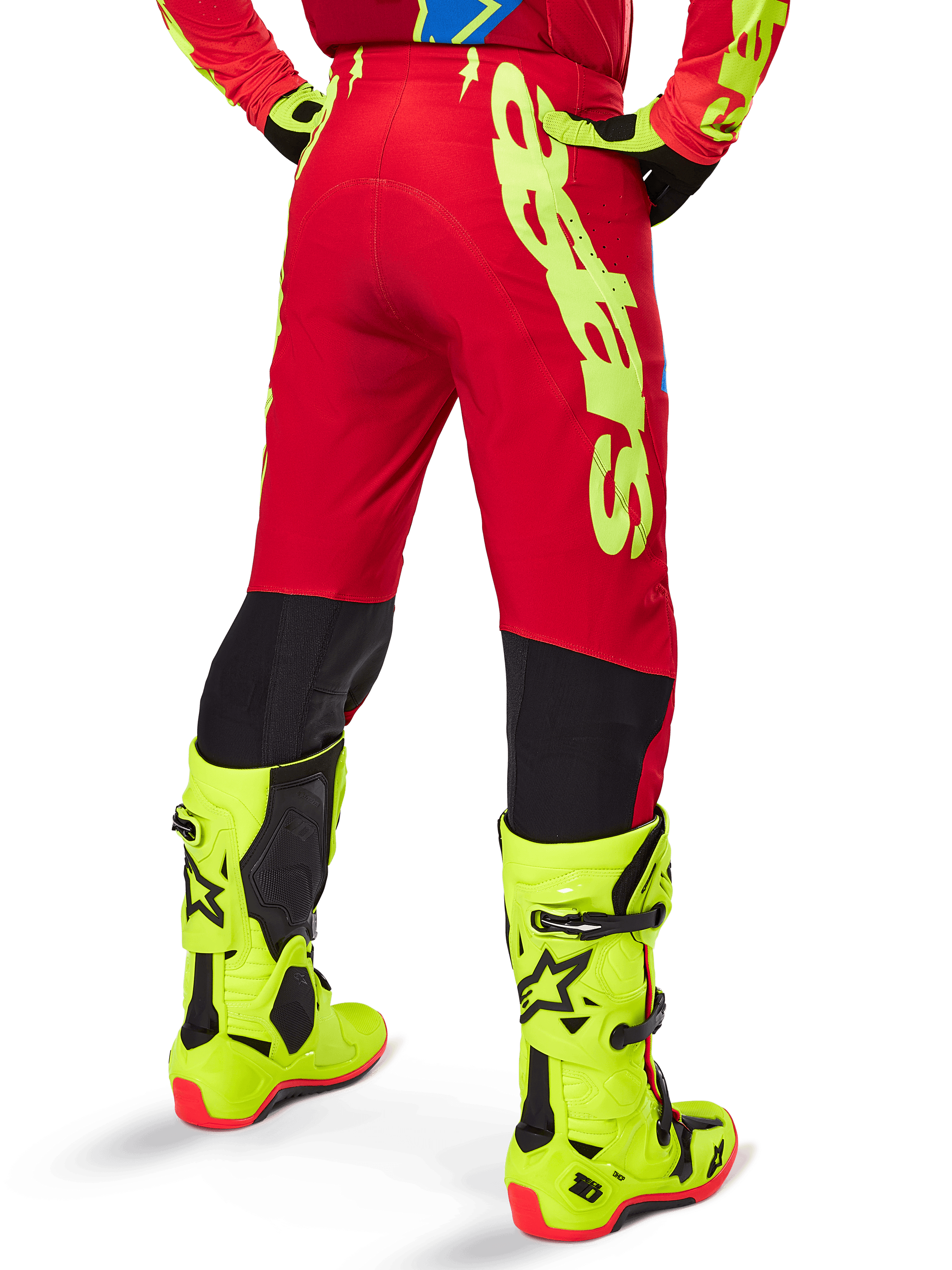 Alpinestars 2025 Supertech Maker Pants, Motocross Pants, Bright Red and Yellow Fluo, back view showing large yellow branding on the side and black panels on the lower legs, worn with coordinating fluo yellow boots and gear