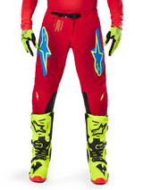 Alpinestars 2025 Supertech Maker Pants, Motocross Pants, Bright Red Yellow Fluo, worn with matching fluo yellow gloves and boots, featuring blue and fluo yellow Astars logos, black inner knee panels, and athletic design for off-road racing