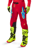Alpinestars 2025 Supertech Maker bukser, motocross-racingbukser, stærk rød med blå og gule stjernelogoer, sorte knæpaneler, perforeret ventilation, koordineret med neongule støvler og handsker