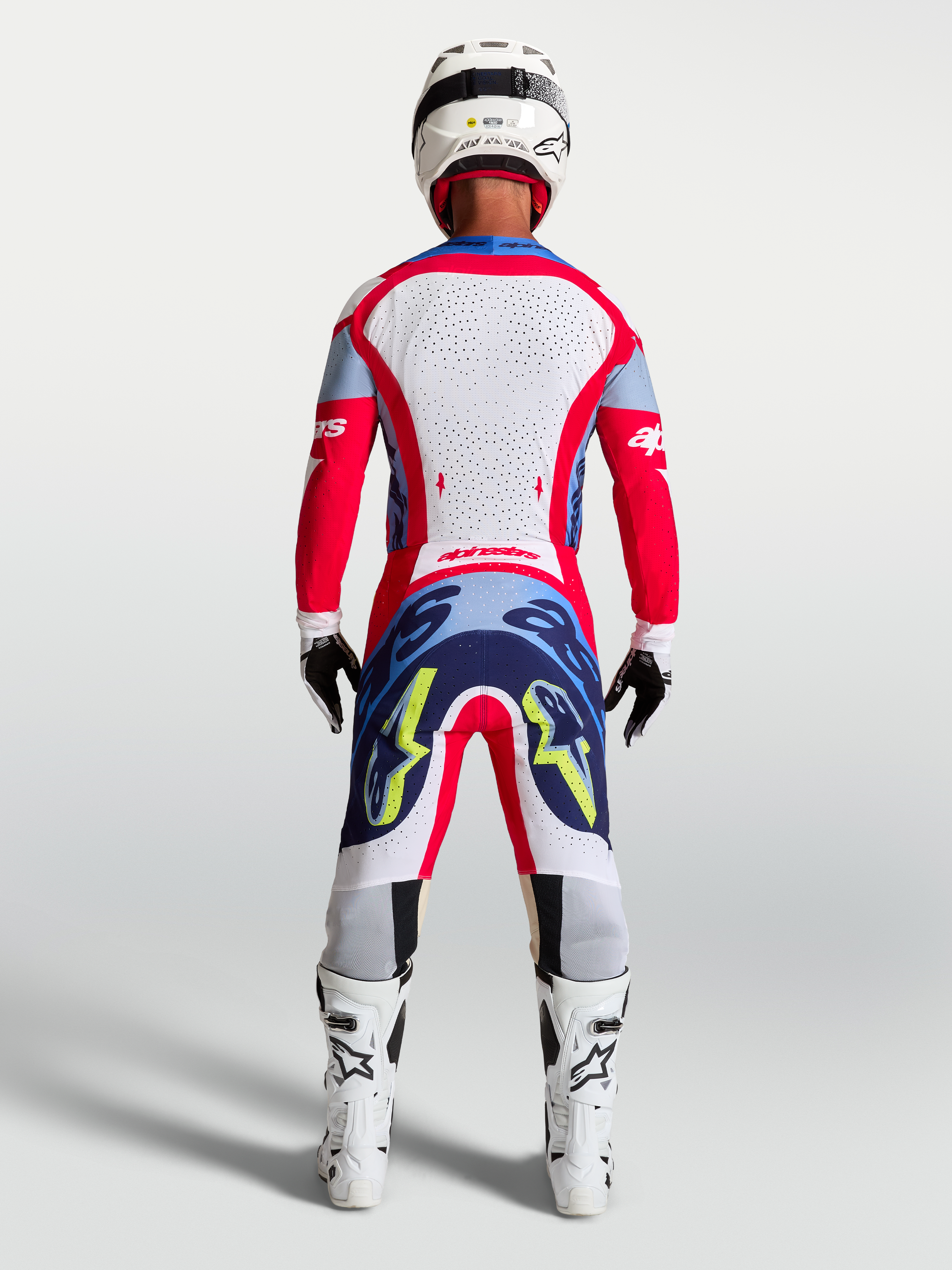 Alpinestars Supertech Dyna Pants, Fire Red and Navy Blue motocross racing gear for men, shown from the rear on model.