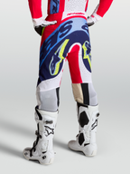 Alpinestars Supertech Dyna Pants, red, white, and navy blue motocross pants with athletic race fit on-model.