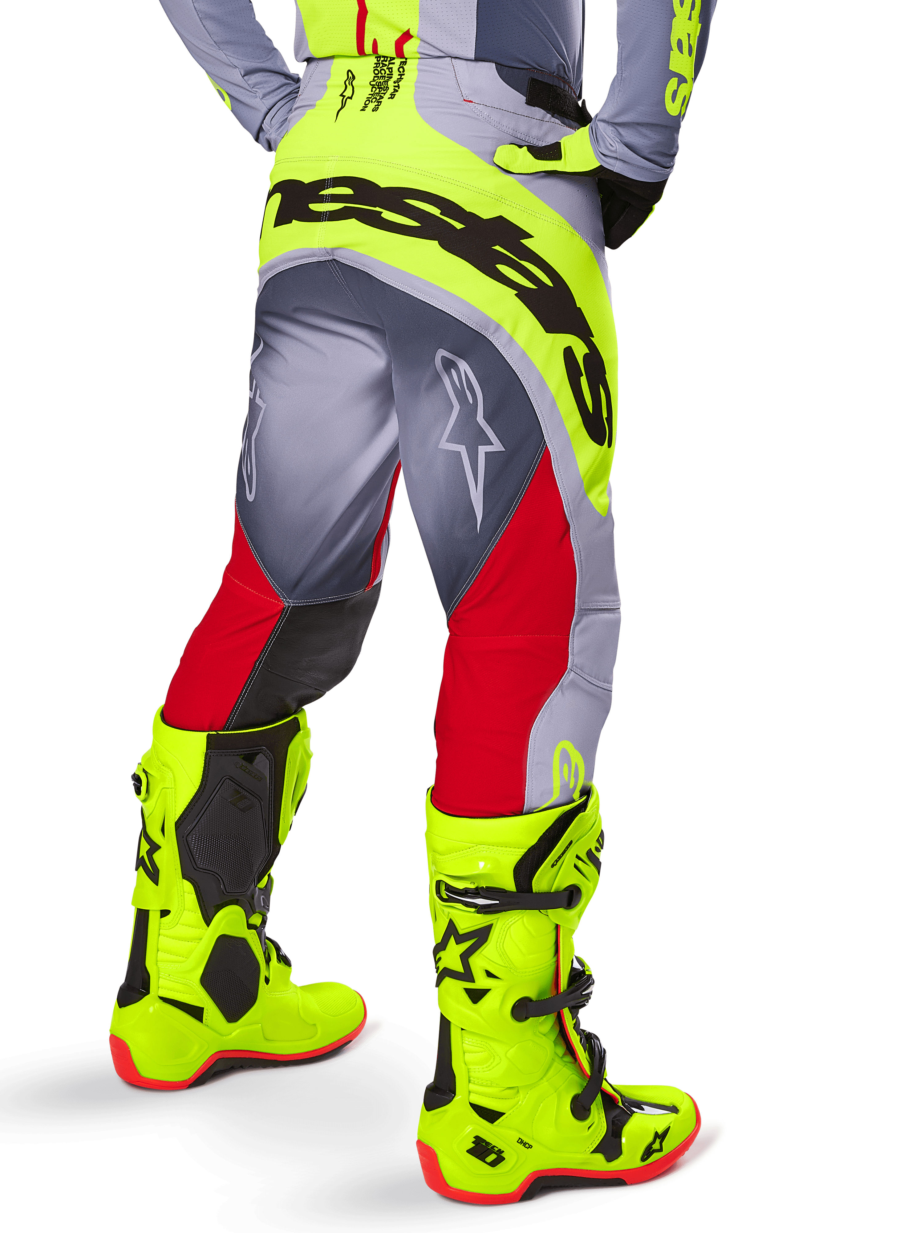 Alpinestars 2025 Techstar Melt Pants, Motocross Pants, Bright Red and Gray with Fluorescent Yellow, back view showing black Alpinestars logo across the seat, paired with matching bright yellow boots, designed for off-road performance