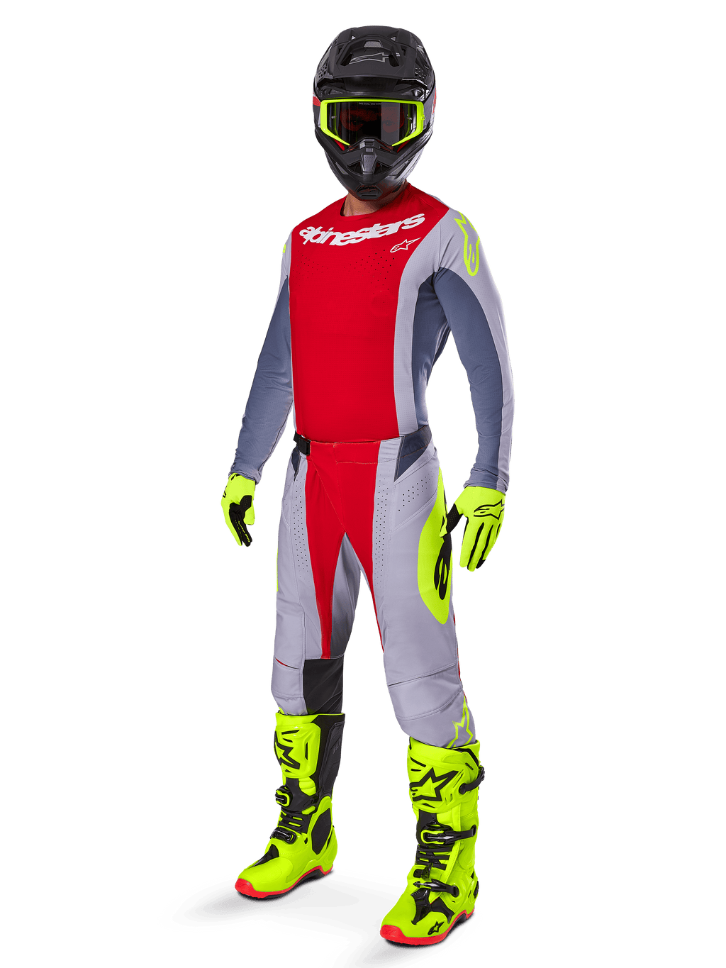 Motocrosskører iført Alpinestars 2025 Techstar Melt Gear Set, rød og grå trøje og bukser, neongule handsker og støvler, sort hjelm, komplet off-road racingudstyr