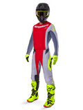 Motocrosskører iført Alpinestars 2025 Techstar Melt Gear Set, rød og grå trøje og bukser, neongule handsker og støvler, sort hjelm, komplet off-road racingudstyr