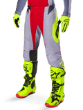 Alpinestars 2025 Techstar Melt Pants, Motocross Pants, Bright Red and Gray, featuring neon yellow side graphics and black knee panels, paired with matching neon yellow boots and gloves, designed for competitive off-road performance