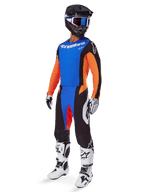 Alpinestars 2025 Techstar Melt Gear Set, Motocross rider wearing blue jersey with orange sleeves, black pants with blue and orange accents, matching black helmet with blue goggles, and white and black racing boots